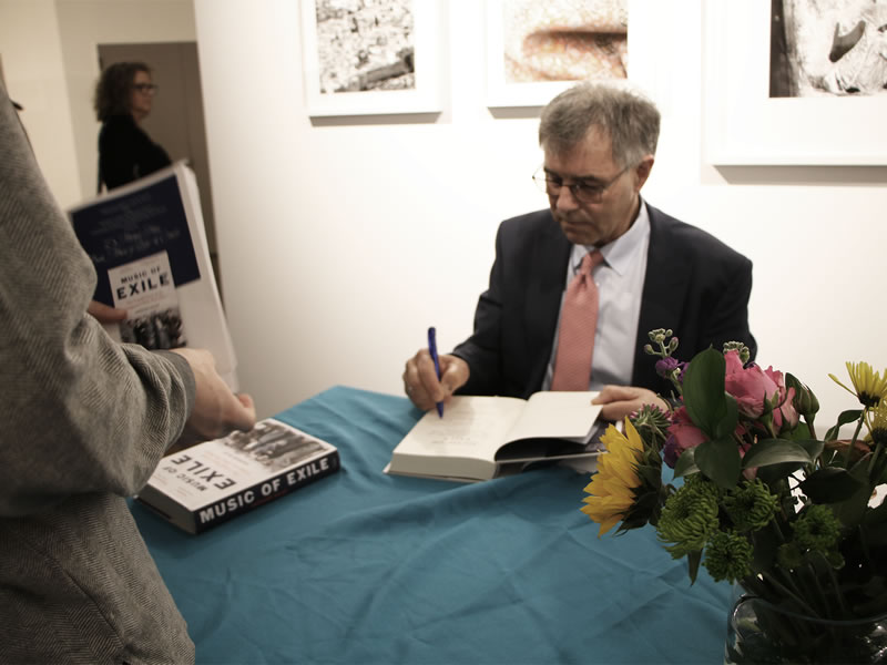 Dr. Michael Haas, Author and Co-founder of Exilarte Center for Banned Music signing the book Music of Exile