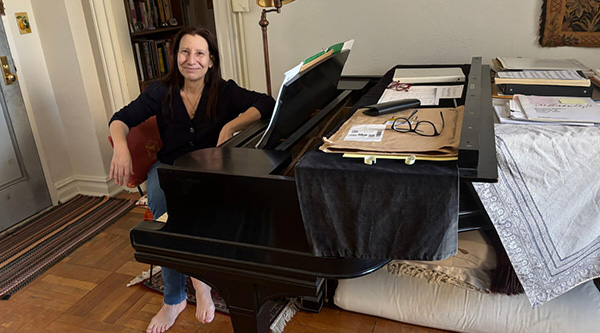Jeanne Golan sitting at her grand piano