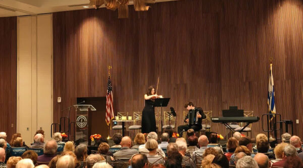 audience view of Kristallnacht Commemoration with violin and classical accordian