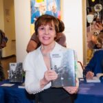 Janie Press holding book "Warsaw Testament"
